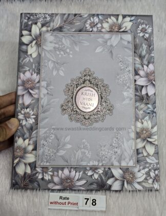 Hardbound floral design wedding invitation card with gold UV foil with matt finish lamination on card and acrylic name plate.