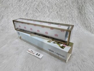 Plastic cube box with slider cover and paper scroll with design and golden foil work on it.