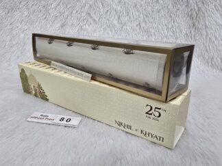 Plastic cube box with slider cover and paper scroll with design and golden foil work on it.