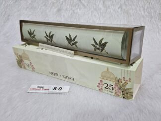 Plastic cube box with slider cover and paper scroll with design and golden foil work on it.